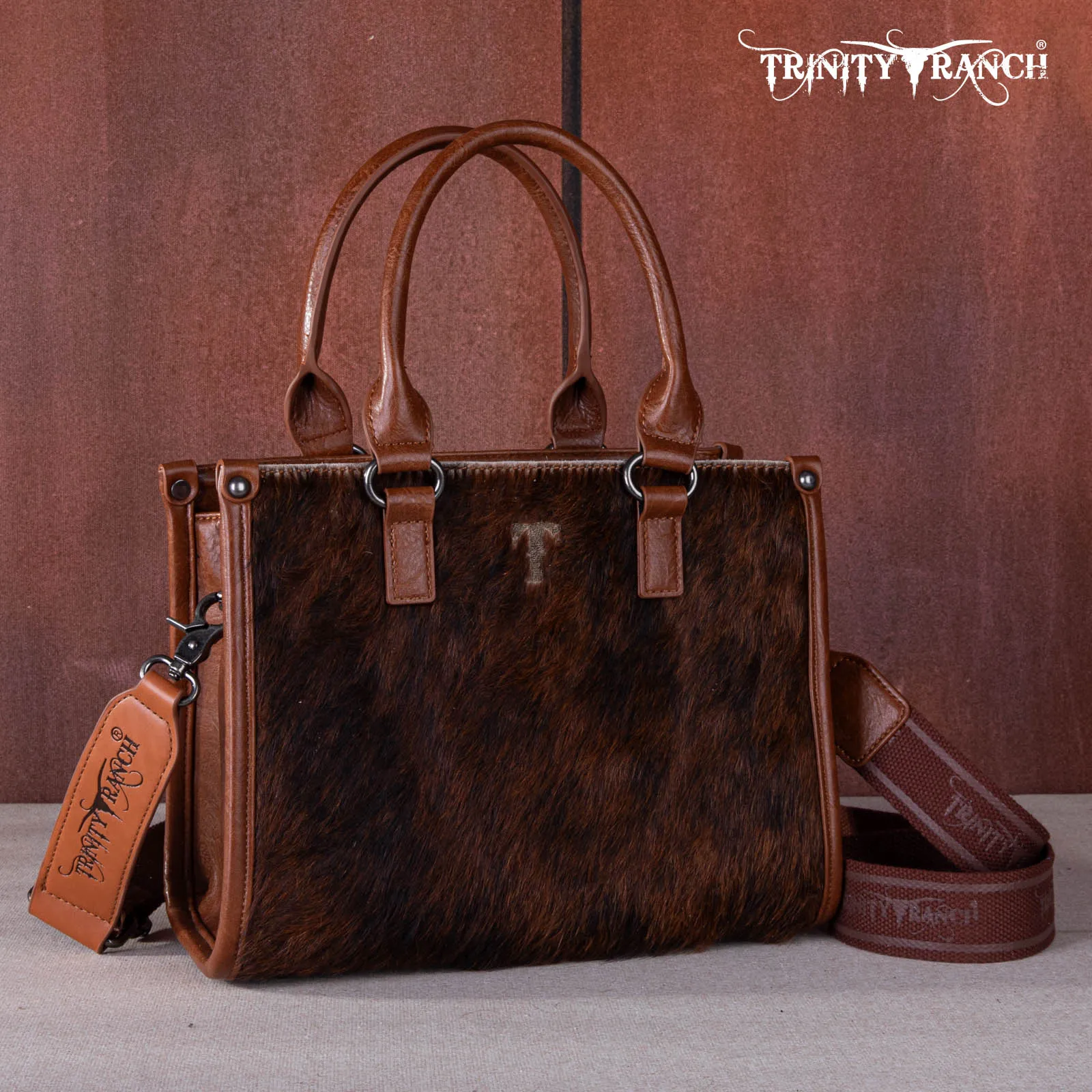 TR164-8250A  Trinity Ranch Hair On Cowhide Tooling Concealed Carry Tote/Crossbody